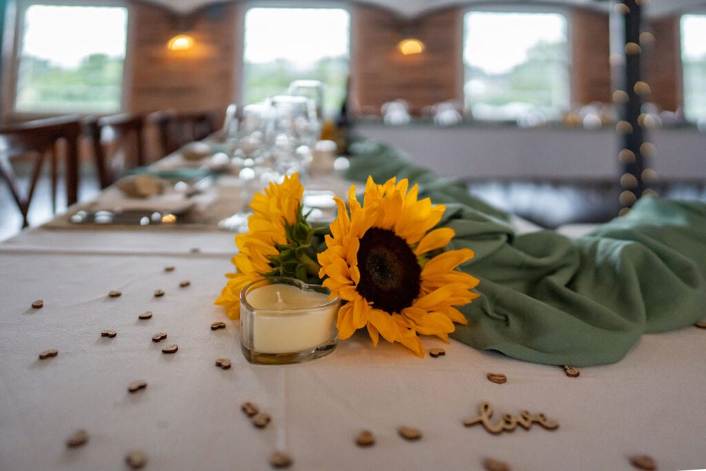Lloyd Dunkley Photography, A wedding table beautifully decorated with sunflowers at the West Mill wedding venue in Derby.